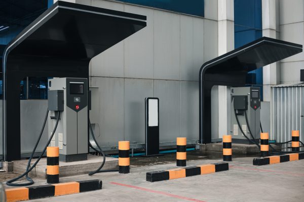 Image of Electric vehicle charging station for charge EV battery. Plug for vehicle with electric engine. EV charger service. Clean energy. Charging point at car parking lot. copy space for text.
